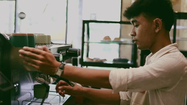 A young barista prepares a cappuccino using a coffee machine in Bali