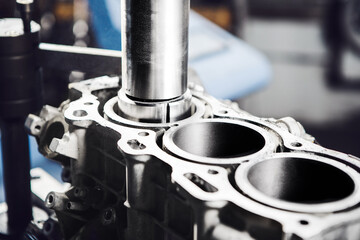 Car engine cylinder head on CNC machine during service boring piston for increase power.