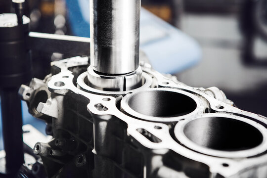 Car engine cylinder head on CNC machine during service boring piston for increase power.