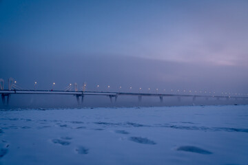 Winter view of an Illuminated bridge crossing the Zeya River in Blagoveshchensk, Russia.