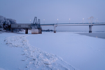 Winter view of an Illuminated bridge crossing the Zeya River in Blagoveshchensk, Russia.