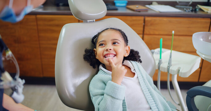 Smile, child and consultation with dentist in office for dental checkup, show cavity and extraction. Happy, kid and paediatric hygienist for oral health, teeth whitening and inspection for cleaning