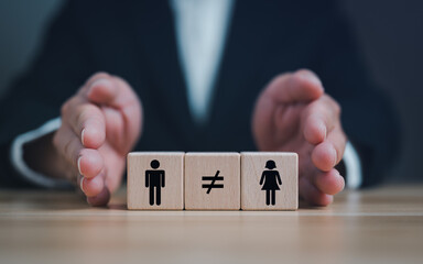 Gender inequality concept. Businessman hands holding wooden cubes with male and female icons...