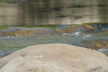 Close up of a large rock in the river for advertising product placement.For graphic design, 3D rendering and banners
