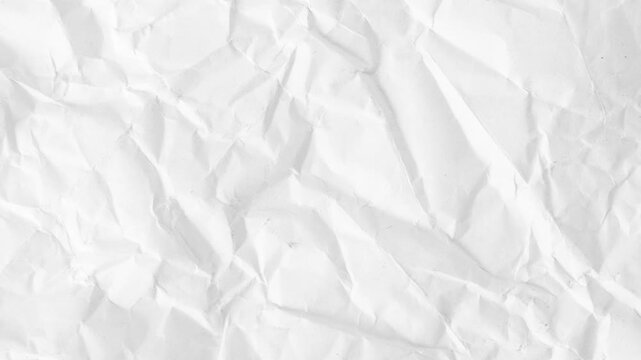 White Crumpled Paper Unfolding Stop Motion Transition.White crumpled paper unfolding animation on black background. Top view of wrinkled sheet opening to reveal texture. Perfect for transitions, intro