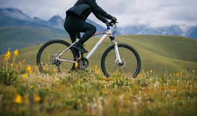 Riding mountain bike on the alpine grassland