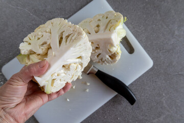 Home cooking concept with raw cauliflower and knife