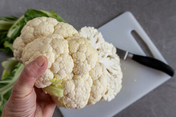 Healthy lifestyle concept with hand holding fresh cauliflower