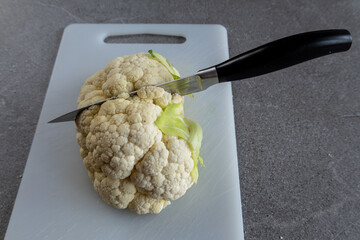 Healthy cooking concept with fresh cauliflower and knife