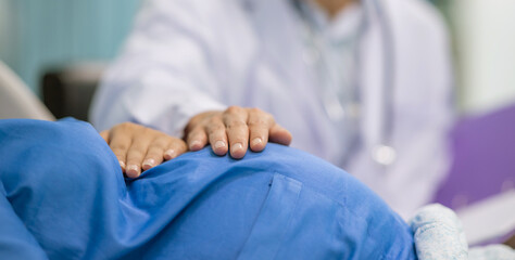Man male obstetrician doctor in white uniform coat gown with stethoscope to check womb stomach in...