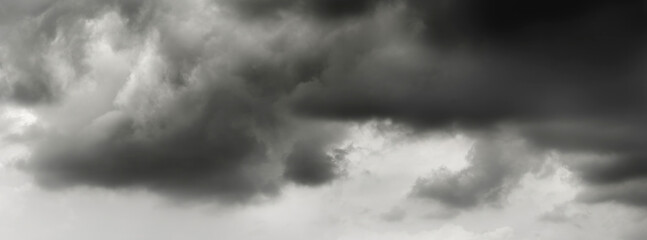 Obraz premium dark clouds make sky in black. Heavy rain thunderstorm. Pattern of clouds overcast predict tornado, Hurricane or thunderstorm and rainy. Dark sky cloudy have storm and lightning thunderbolt.