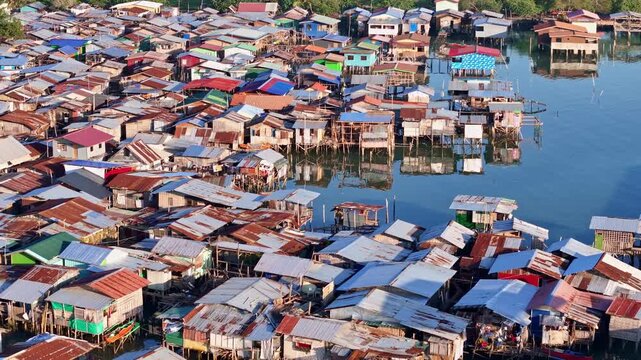 Poverty stricken home along the coast of Davao City Philippines. Stilt slum neighborhoods with no sanitation home thousands of Filipinos.