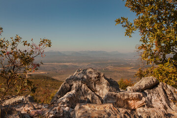 Panoramic view from the top of Mount Križevac in Medjugorje with the iconic cross overlooking the town, a sacred pilgrimage site symbolizing Christian faith, prayer, and spiritual reflection.