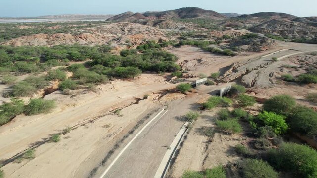 Aerial view of road transitioning from asphalt to dirt in Araya