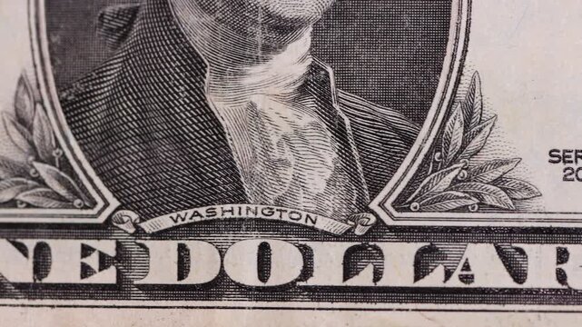 Macro view of one-dollar banknotes arranged in a row, representing the concept of the foreign exchange market and the strength or devaluation of the US dollar.