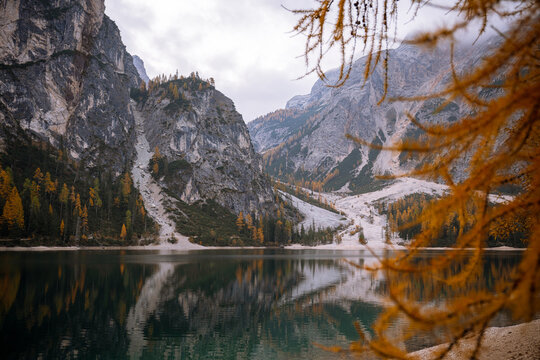 Autumn colors at Lago di Braies in Dolomites with mountain reflections