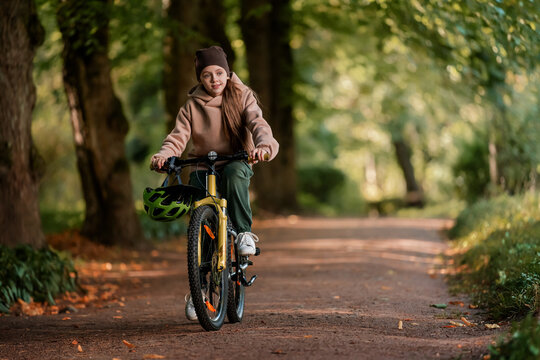 Happy kid enjoying bike ride in nature on a sunny day.