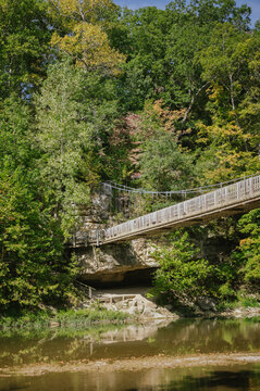 Wooden suspension bridge over creek at Turkey Run State Park in fall