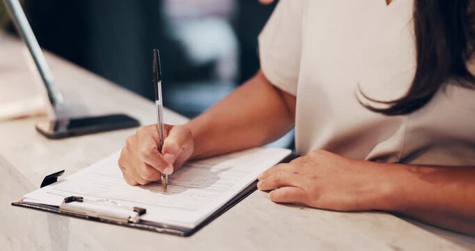 Woman, hands or writing with form at reception desk for reservation, check in or stay in salon. Closeup, female person or filling documents with policy for schedule service or agreement in beauty spa