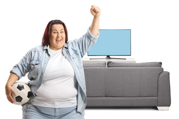 Chubby young woman cheering with a football