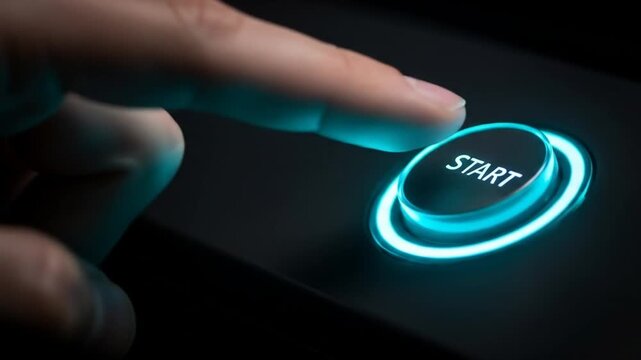 Finger actively presses glowing blue 'START' button on a dark control panel