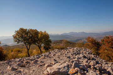 Panoramic view from the top of Mount Križevac in Medjugorje with the iconic cross overlooking the town, a sacred pilgrimage site symbolizing Christian faith, prayer, and spiritual reflection.
