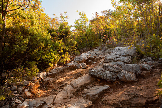 Steep rocky path leading to Mount Križevac in Medjugorje, the difficult pilgrimage road to the Krizevac Cross, symbolizing faith, endurance, prayer, and spiritual journey.