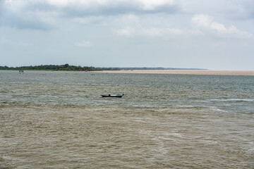 The meeting of the blue waters of the Tapajos River and muddy of the Amazon River in Santarem, Para State, Brazil.