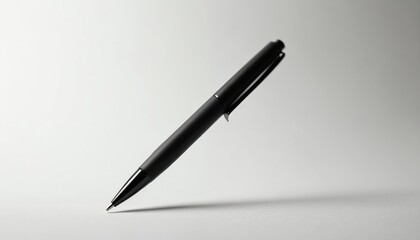 A modern black pen rests on a clean white surface. This writing instrument is angled, casting a subtle shadow. Its elegant design suggests sophistication for business or personal use.