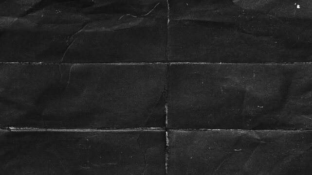 Black Folded Paper Texture with Scratches and Dust Overlay.Dark folded paper background featuring animated scratches and dust. Grunge vintage texture overlay for retro cinematic effects 