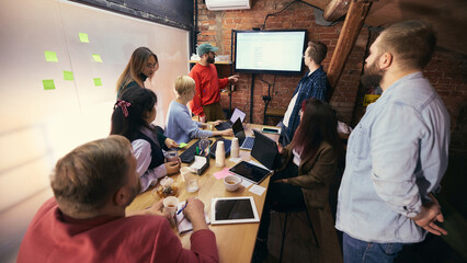 Startup team planning session around table in modern office. Concept of agile workflow,...