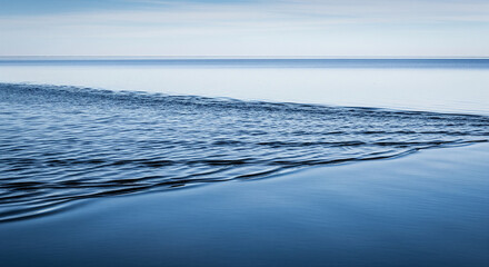  A minimalist scene a vast, still lake surface suddenly disturbed by a strong, chaotic wind. The water is covered in sharp, choppy, overlapping ripples that fracture the reflection of a clear blue sky