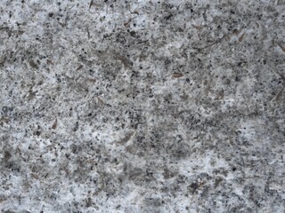 A dirty snowy surface with soil and natural particles, snow-covered asphalt. Textured background, top view. Winter season concept for design.
