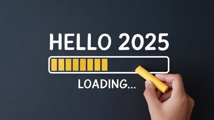 Hand holding yellow chalk writing hello 2025 on dark background with loading progress bar