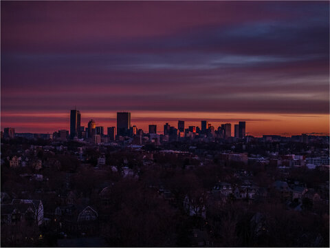 Aerial view of the skyline with the Prudential Center and other buildings silhouetted against the fading light, Boston, Massachusetts, United States.