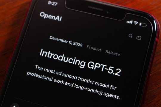 Quito, ECUADOR - Dec 15 2025 : Close-up of a phone screen displaying OpenAI's GPT-5.2 product release announcement, in dark mode.