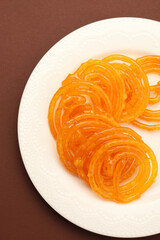 Sweet Jalebi, a popular Indian dessert, golden spirals of fried batter soaked in syrup.