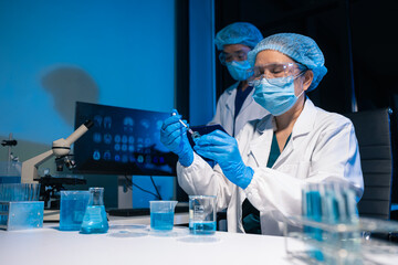 Lab work, Doctor holds a test tube takes the test from a test tube in analysis, blood, DNA, test tube stand.