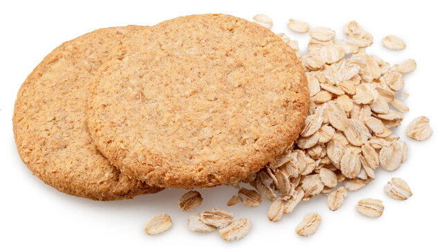 Oatсakes or oat biscuits and several rolled oats isolated on white background. File contains clipping paths.
