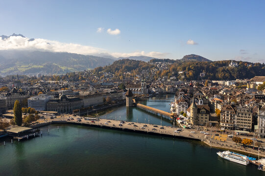 Aerial view of the Reuss River winding through the heart of the city, framed by historic buildings and distant mountains, Lucerne, Lucerne, Switzerland.