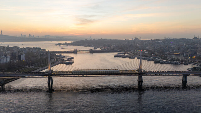 Istanbul cityscape showing golden horn and halic metro bridge at sunrise