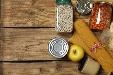 Humanitarian aid. Different food products for donation in crate on wooden table