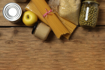 Humanitarian aid. Different food products for donation in crate on wooden table
