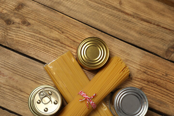 Humanitarian aid. Different food products for donation in crate on wooden table