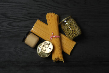 Humanitarian aid. Different food products for donation in crate on wooden table