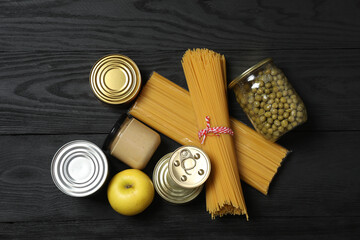 Humanitarian aid. Different food products for donation in crate on wooden table