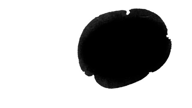A black ink blotch with irregular edges on a white background.