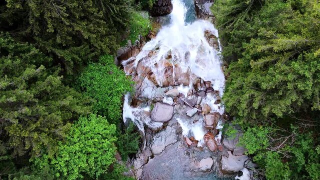 Aerial of V&ograve; Waterfall in Val di Scalve, Italian Dolomites and Alpi Orobie, surrounded by lush alpine pine forests and dense mountain vegetation