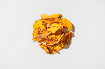 Dried peach slices scattered on light background, pattern. Organic tasty sweet dried fruit, healthy dessert, vitamins and fiber. Food background flat lay top view. Vegetarian snack