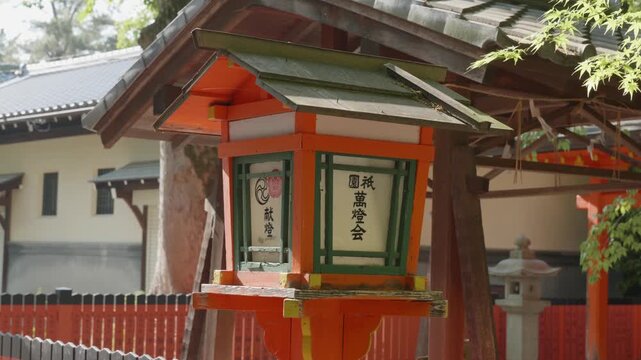 Traditional japanese red lantern during daytime at temple Yasaka Jinja, Gion, Kyoto, Japan.